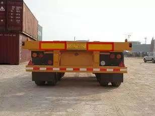 Rimorchio a base piatta d'acciaio dei semi con la gomma del triangolo 12R22.5 40 piedi di trasporto in container